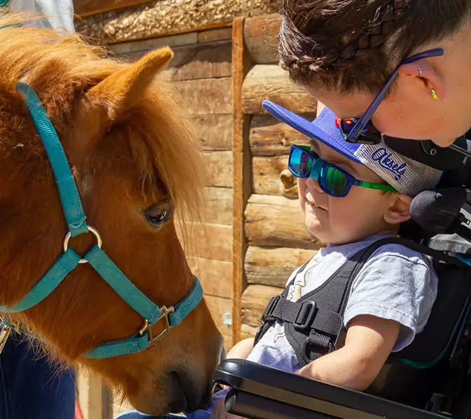 Gabriel spending time with a horse