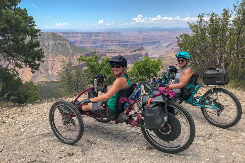 Two riders stopping for a photo with the Grand Canyon in the background