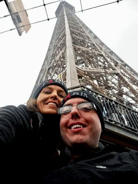 Cory and his mother below the Eiffel Tower