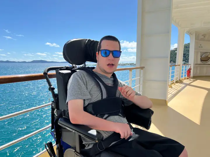 A young man using a wheelchair at a lake