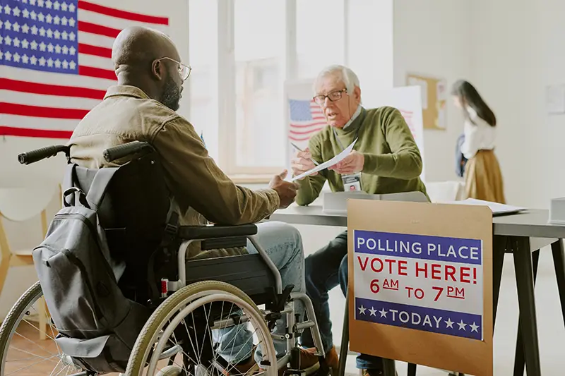 A man in a wheelchair at a polling location